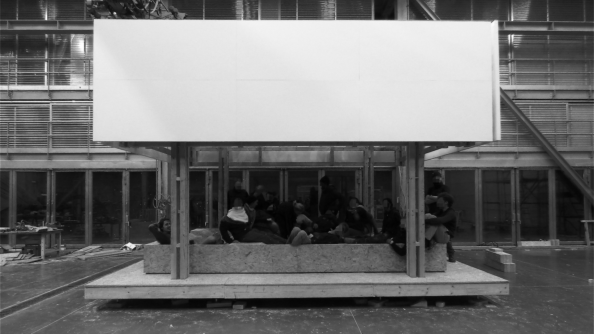 A view of the completed project with the whole team sitting inside it in the workshop